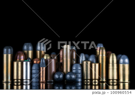 Ammuninition isolated on black background with reflexion. Different cartridges for rifle, pistols and revolvers on a black. 100960554