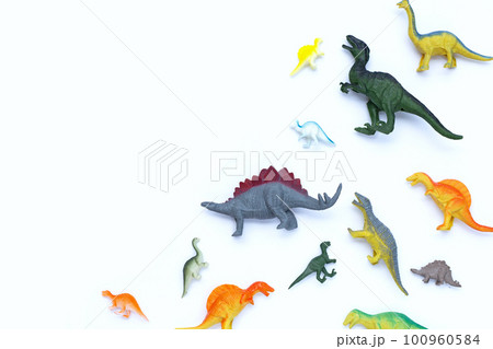 Plastic dinosaur toys on white background. Top view 100960584