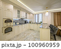 Cream colored classic kitchen with island used as dining area in studio apartment 100960959