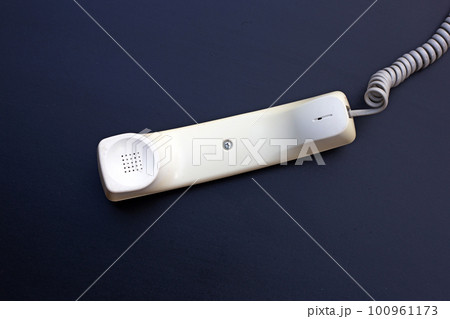 Handset of landline phone on dark background. Handset of landline phone on dark background. 100961173