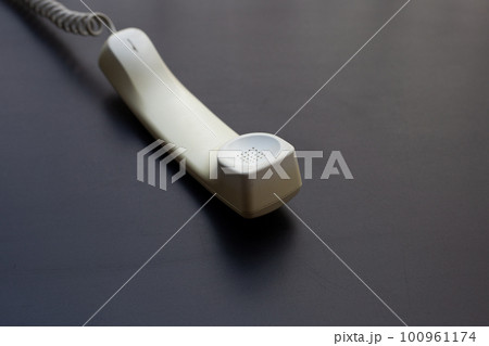 Handset of landline phone on dark background. Handset of landline phone on dark background. 100961174