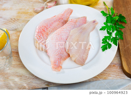 Fresh raw fillet of sea bass 100964923