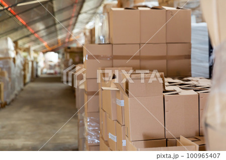 Warehouse - boxes with various goods on racks and on floor Warehouse - boxes with various goods on racks and on floor 100965407