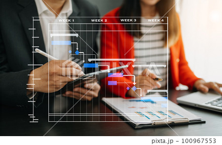 Project manager working and update tasks with milestones progress planning and Gantt chart scheduling diagram.business tram working at office. 100967553