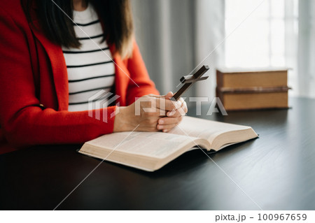 Woman praying on holy bible in the morning.Woman hand with Bible praying. Christian life crisis prayer to god... 100967659