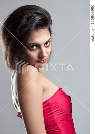 Female wearing a red corset Female wearing a red corset 100968990