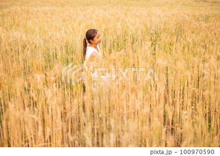 Young Asian women  in white dresses  in the Barley rice field 100970590