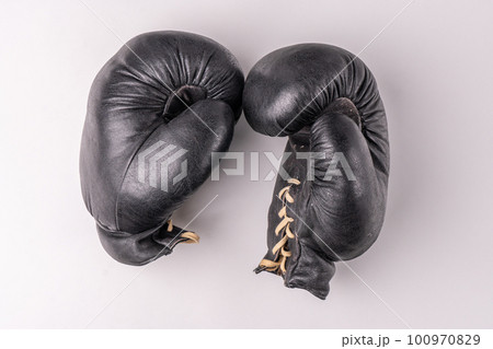 Old boxing gloves made of genuine leather. Retirement concept 100970829