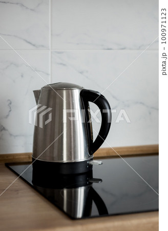 electric kettle on the stove kitchen. 100971123