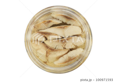 Sliced salted and pickled herring fish in jar isolated on white background.  100971593