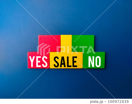 Top view colored wooden puzzle with the word YES SALE NO on blue background. Business concept. Top view colored wooden puzzle with the word YES SALE NO on blue background. Business concept. 100972839
