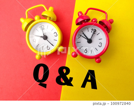 Colored alarm clock with the word Q AND A on a colored background. Colored alarm clock with the word Q AND A on a colored background. 100972840