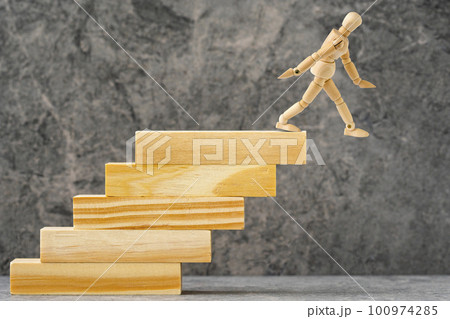 Wooden mannequin falling down from stairs Wooden mannequin falling down from stairs 100974285