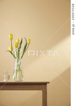 A cozy home with sunlight shining through the windows and fresh flowers 100974508