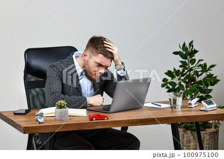 man sitting on chair at table and resting, using laptop man sitting on chair at table and resting, using laptop 100975100