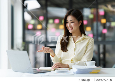 Beautiful Asian Banker or Accountant makes financial report and tax, analyzes profits. Accountant checks status of financial Beautiful Asian Banker or Accountant makes financial report and tax, analyzes profits. Accountant checks status of financial 100975710