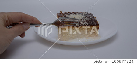 Turkish traditional dessert of ramadan on white background .tralice. Three milk cake turkish style. close-up Turkish traditional dessert of ramadan on white background .tralice. Three milk cake turkish style. close-up 100977524