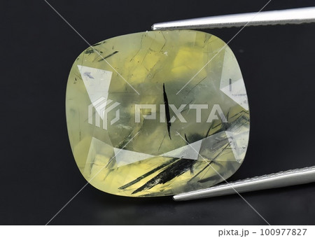 Natural gemstone green prehnite on gray background Natural gemstone green prehnite on gray background 100977827