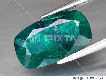 Natural gemstone green dioptase on a gray background Natural gemstone green dioptase on a gray background 100977871