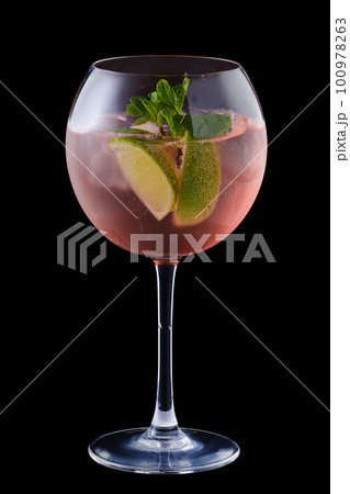 Cold sangria with lime and mint in a wine glass Cold sangria with lime and mint in a wine glass 100978263