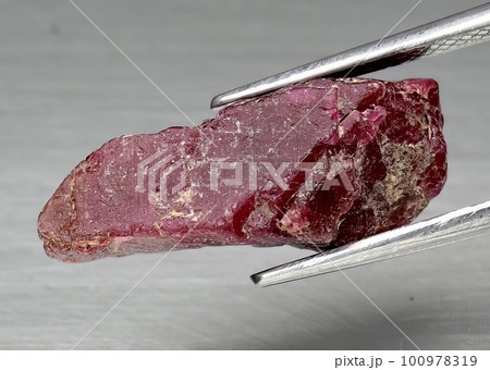 Natural gem red ruby on gray background Natural gem red ruby on gray background 100978319