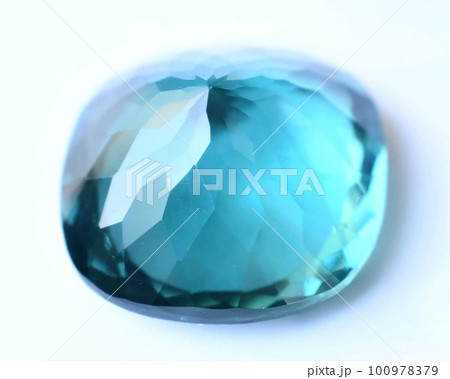 Natural gemstone blue tourmaline indicolite on gray background Natural gemstone blue tourmaline indicolite on gray background 100978379