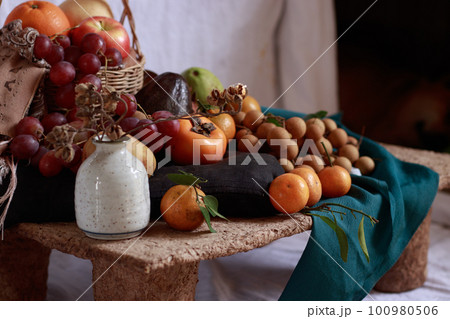 A table filled with twelve different round sweet fruits, a Filipino belief and ritual to bring luck in the New Year 100980506