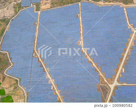Solar cell panels at solar farm, drone view. Green energy concept. Solar cell panels at solar farm, drone view. Green energy concept. 100980582