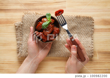 Concept of tasty food - delicious dried tomato Concept of tasty food - delicious dried tomato 100982200