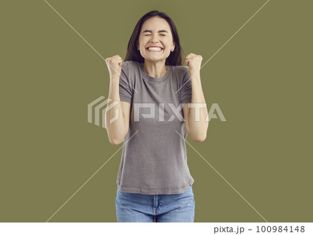 Happy pretty smiling young woman in brown T-shirt and blue jeans on isolated background. Happy pretty smiling young woman in brown T-shirt and blue jeans on isolated background. 100984148