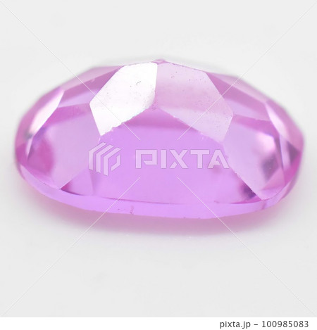 Natural gemstone pink sapphire on gray background 100985083