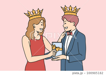Smiling couple with crowns on heads with present  100985182