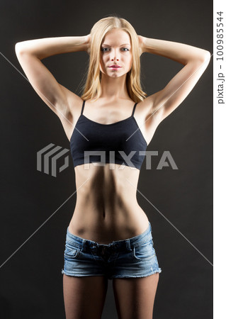 Woman activewear. Clothing template. Sport fashion. Gym outfit. Unrecognizable female athlete slim body in logo mockup design black mesh bra shorts isolated on white copy space advertising background. Woman activewear. Clothing template. Sport fashion. Gym outfit. Unrecognizable female athlete slim body in logo mockup design black mesh bra shorts isolated on white copy space advertising background. 100985544