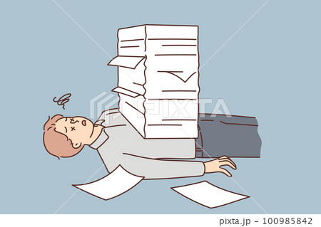 Stressed man lying under paperwork pile  100985842