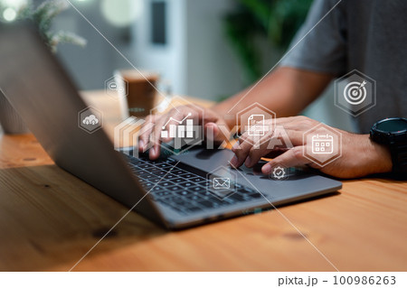 Marketing and communication plan concept with person using a laptop on a table Marketing and communication plan concept with person using a laptop on a table 100986263