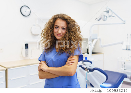 Portrait of young woman dentist at private dental clinic. 100988213