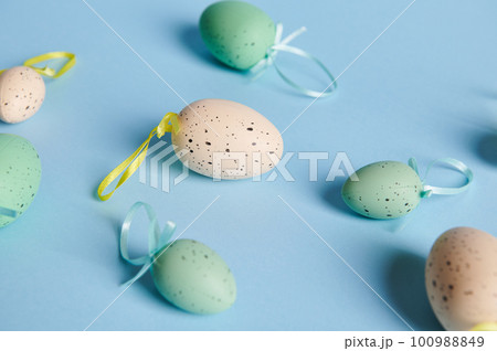 Flat lay with beige and blue cyan pastel Easter eggs on isolated color background with copy advertising space. Still life. Easter celebration concept. Top view 100988849