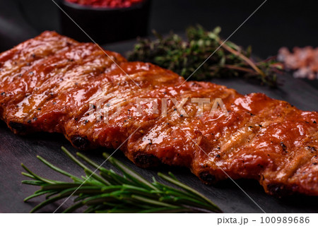 Delicious fresh grilled or smoked ribs with salt, spices and herbs Delicious fresh grilled or smoked ribs with salt, spices and herbs 100989686