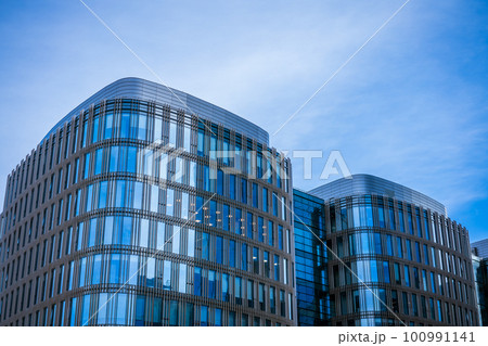 Glass facades of buildings against the sky Glass facades of buildings against the sky 100991141