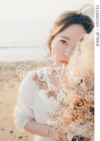 ドライフラワーを持って海を見つめる女性 ドライフラワーを持って海を見つめる女性 101000732