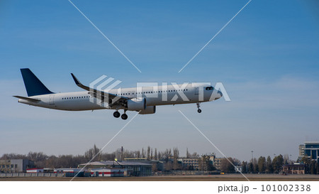 Ground view of a landing plane against a blue sky. Ground view of a landing plane against a blue sky. 101002338