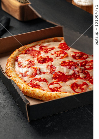 Take away packed pepperoni pizza with salami 101004731