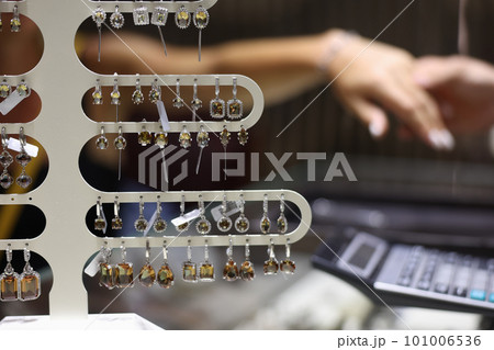 Lot of precious earrings with stones sold in jewelry store closeup Lot of precious earrings with stones sold in jewelry store closeup 101006536