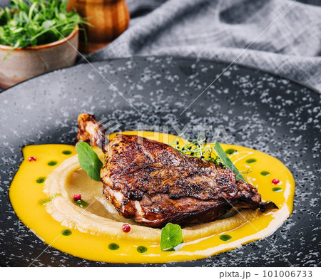 Roast duck leg with mashed green vegetables Roast duck leg with mashed green vegetables 101006733