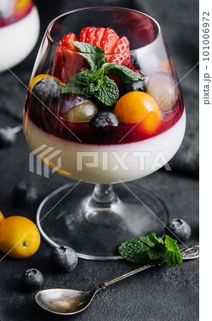 Dessert, creamy panna cotta with cherry sauce with fresh berries 101006972