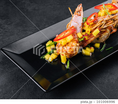 Skewers barbeque grilled prawns on black plate Skewers barbeque grilled prawns on black plate 101006996