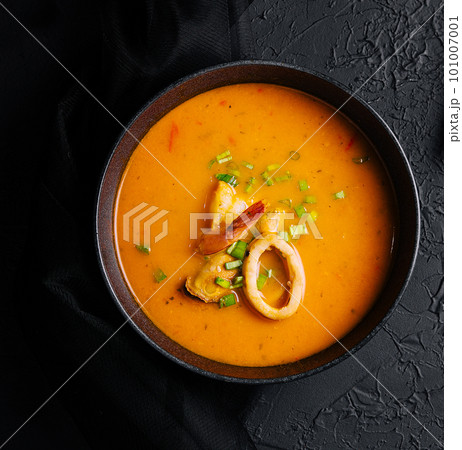 Tom yam seafood soup from above on black stone Tom yam seafood soup from above on black stone 101007001