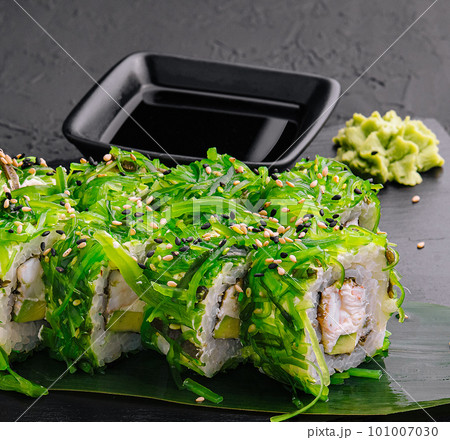Sushi rolls with seafood and chuka salad Sushi rolls with seafood and chuka salad 101007030