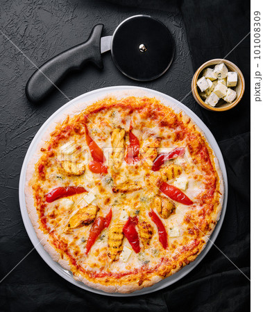 Hot delicious traditional italian pizza on a dark stone background 101008309