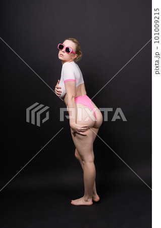 Young woman posing in underwear studio background. Perfect plump body, seductive lingerie. Young woman posing in underwear studio background. Perfect plump body, seductive lingerie. 101009215